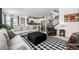 Spacious open-concept living area flows into the kitchen, featuring modern decor and an abundance of natural light at 9350 Dunraven St, Arvada, CO 80007
