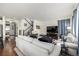 Bright living room with hardwood floors, gray sofas, and a staircase at 9350 Dunraven St, Arvada, CO 80007