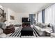Cozy living room featuring a large TV, comfortable sofas, and ample natural light at 9350 Dunraven St, Arvada, CO 80007