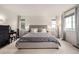 Calm main bedroom with neutral tones, carpet, large windows, and stylish furnishings at 9350 Dunraven St, Arvada, CO 80007