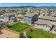A spacious, fenced backyard on a blue two-story house with grass and gravel landscaping, offering a private outdoor space at 9350 Dunraven St, Arvada, CO 80007