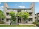 Multi-story condo building featuring well-maintained grounds and a welcoming entrance at 3100 S Federal Blvd # 232, Denver, CO 80236