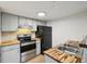 Modern kitchen featuring butcher block countertops and stainless steel appliances at 3100 S Federal Blvd # 232, Denver, CO 80236