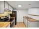 Bright kitchen featuring butcher block countertops and stainless steel appliances at 3100 S Federal Blvd # 232, Denver, CO 80236