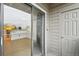 View through sliding glass doors into a living room with wood floors and an adjacent modern kitchen at 3100 S Federal Blvd # 232, Denver, CO 80236