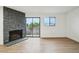 Bright living room with stone fireplace and sliding door access to the balcony at 3100 S Federal Blvd # 232, Denver, CO 80236