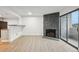Open floor plan features a stone fireplace, bar seating, and balcony access at 3100 S Federal Blvd # 232, Denver, CO 80236