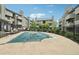 Community pool surrounded by a wrought iron fence and seating at tables at 3100 S Federal Blvd # 232, Denver, CO 80236