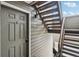 Exterior view of a staircase leading to an apartment, with a door next to the stairs at 3100 S Federal Blvd # 232, Denver, CO 80236