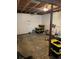 Unfinished basement with workout equipment and large storage bins on the floor at 19645 E Buchanan Pl, Aurora, CO 80011