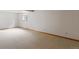 Spacious basement featuring neutral colored carpeting, a window and white walls at 2040 Yarrow St, Lakewood, CO 80214