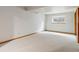 Finished basement with a window, and white walls, and light colored carpeting at 2040 Yarrow St, Lakewood, CO 80214