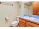 Bathroom with a toilet, sink, a vanity, and a shower-tub combination at 2040 Yarrow St, Lakewood, CO 80214