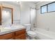 Bathroom featuring a vanity, toilet, mirror and shower at 2040 Yarrow St, Lakewood, CO 80214
