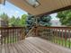 Wooden back deck with a covered roof, and lush trees at 2040 Yarrow St, Lakewood, CO 80214