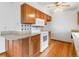 Kitchen showcases a microwave, oven, granite counters, white appliances, and wooden cabinets at 2040 Yarrow St, Lakewood, CO 80214