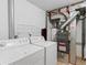 Equipped laundry room featuring appliances and water heater at 2040 Yarrow St, Lakewood, CO 80214