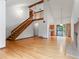 Spacious living room featuring hardwood floors, a staircase, and a brick fireplace at 2040 Yarrow St, Lakewood, CO 80214