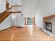 Bright and airy living room showcasing hardwood floors and a brick fireplace at 2040 Yarrow St, Lakewood, CO 80214