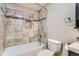 Nicely tiled bathroom featuring a shower, toilet, and tiled inset in the shower at 5191 S Nepal Way, Centennial, CO 80015
