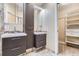 Modern bathroom with double sink vanities, decorative mirrors, and a well-organized walk-in closet at 5191 S Nepal Way, Centennial, CO 80015