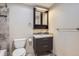 Modern bathroom with a stylish vanity, gray accent wall, and tiled floors at 5191 S Nepal Way, Centennial, CO 80015