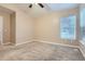 A bright bedroom features neutral carpet, light-colored walls, a ceiling fan, and a window at 5191 S Nepal Way, Centennial, CO 80015