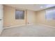Inviting bedroom features neutral walls, plush carpeting, and natural light from two windows at 5191 S Nepal Way, Centennial, CO 80015