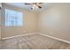 A bedroom with tan carpet, neutral walls, window with blinds, and a ceiling fan at 5191 S Nepal Way, Centennial, CO 80015