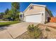 Attractive home with a two car garage, manicured lawn, and established landscaping at 5191 S Nepal Way, Centennial, CO 80015