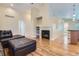 Spacious living room with a cozy fireplace and ample natural light at 5191 S Nepal Way, Centennial, CO 80015