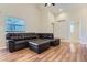 Large living room featuring sleek hardwood floors and a plush sectional sofa at 5191 S Nepal Way, Centennial, CO 80015