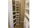 A walk-in closet features built-in shelves and rods for optimal organization and storage at 5191 S Nepal Way, Centennial, CO 80015