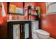 Stylish bathroom with modern vanity, black framed mirror, and a toilet with shelving above at 1632 N Gilpin St, Denver, CO 80218