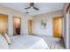 Bedroom with neutral tones, a ceiling fan, and multiple doorways leading to other rooms at 1632 N Gilpin St, Denver, CO 80218
