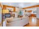 Cozy living room featuring a fireplace, hardwood floors, and an open layout to the kitchen at 1632 N Gilpin St, Denver, CO 80218