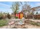 Charming backyard patio with seating, garden shed, wooden pergola, and grill, ideal for outdoor entertaining at 6625 S Ogden St, Centennial, CO 80121