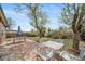 Well-maintained backyard patio with outdoor dining set, shaded seating, and lush green lawn, perfect for relaxation at 6625 S Ogden St, Centennial, CO 80121