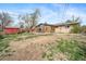Expansive backyard with a lush green lawn, patio area, and mature trees, ideal for outdoor activities and relaxation at 6625 S Ogden St, Centennial, CO 80121