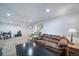 Basement offering seating, dark coffee table, and staircase access to upper levels at 6625 S Ogden St, Centennial, CO 80121