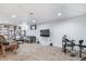 Basement featuring dark coffee table, TV, seating, and a drum set for entertainment at 6625 S Ogden St, Centennial, CO 80121