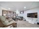 Basement featuring built-in shelving, couches, TV, and ambient lighting for a cozy retreat at 6625 S Ogden St, Centennial, CO 80121