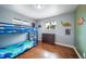 Cozy bedroom featuring a bunk bed, hardwood floors, and windows that offer natural light at 6625 S Ogden St, Centennial, CO 80121