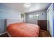 Cozy bedroom featuring hardwood floors, a large bed, and natural light from the window at 6625 S Ogden St, Centennial, CO 80121