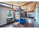 Unique bonus room with climbing wall, wood ceiling, and large windows at 6625 S Ogden St, Centennial, CO 80121