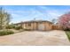Ranch style house showing a driveway, a garage, and a basketball hoop behind a fence at 6625 S Ogden St, Centennial, CO 80121