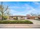 Charming brick home featuring an attached garage, landscaped front yard, and a beautifully maintained lawn at 6625 S Ogden St, Centennial, CO 80121