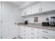 Functional kitchen area with white cabinetry, countertops, and essential appliances at 6625 S Ogden St, Centennial, CO 80121