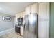 Kitchen with stainless steel refrigerator and appliances, light wood cabinets and tiled floors at 6625 S Ogden St, Centennial, CO 80121