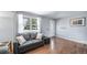The living room features hardwood floors, ample natural light, and a comfortable sofa at 6625 S Ogden St, Centennial, CO 80121